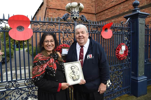Stewart Harrison and Sheila Caberwal holding a picture of her late father Jagat Caberwal.
PICTURE: ANDREW CARPENTER