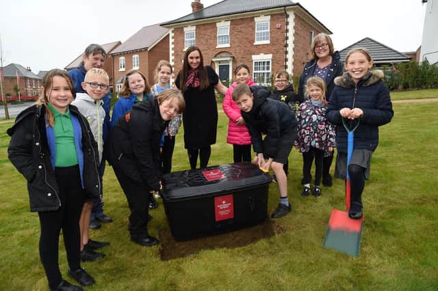 Lubenham Primary School pupils bury the time capsule at Lubenham View, watched by head of school Susan Foster, teacher Chris Gordon, and Davidsons Homes’ sales manager Kelly Cooper-Velthinjsen