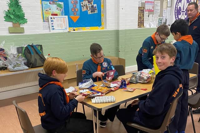 Scouts in Market Harborough are hard at work making survival bags for homeless people – out of empty crisp packets.