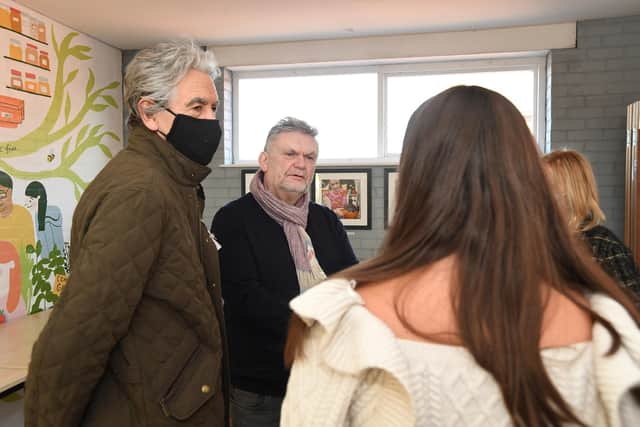 Photographer Mark A Phillips (centre) during his exhibition at the EcoVillage.
PICTURE: ANDREW CARPENTER