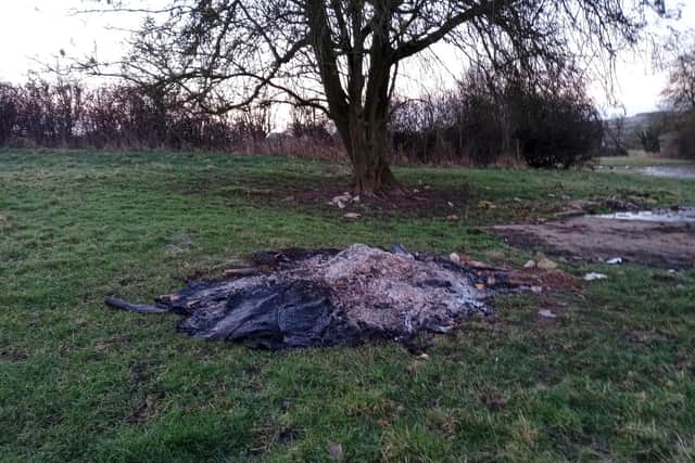 A load of rubbish was fly-tipped into a scenic meadow near Market Harborough before being set alight.