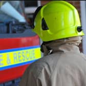 An injured woman was cut free from her vehicle by firefighters after a car collided with a van near Lutterworth yesterday afternoon (Thursday).