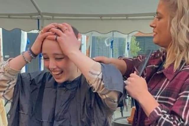 Liv Kendrick, 17, had her head shaved at the Admiral Nelson pub on the town’s Nelson Street on Saturday evening (March 19) as her family and friends looked on.