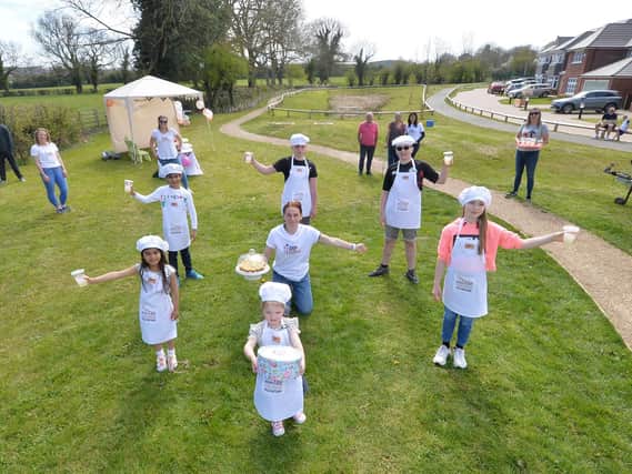 Centre, organiser Charlotte Smith with junior bakeoff youngsters during the Stand Up For Cancer event on Berry Close in Great Bowden on Sunday.
PICTURE: ANDREW CARPENTER