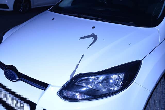 Vehicles daubed with paint stripper on Caxton Street during late Saturday evening.
PICTURE: ANDREW CARPENTER
