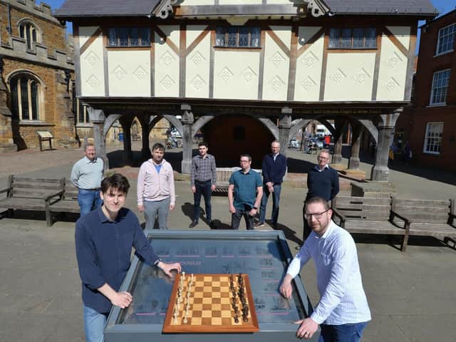 Alistair Geear (left) and Jon Redding at the chess board in front of fellow Harborough Cuatro members (from left) John Thomson, Rene Butler, Mark Waterfield, Mike Garland, Robert Gibbison and Dave Walker. Picture by Andrew Carpenter