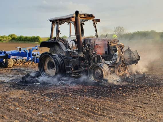 A tractor driver escaped uninjured after their vehicle burst into flames as they ploughed a field near Tugby.