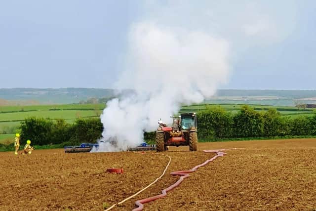 A tractor driver escaped uninjured after their vehicle burst into flames as they ploughed a field near Tugby.