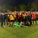 The Harborough Town players and staff celebrate after they beat ON Chenecks 2-0 in the final of the United Counties League’s supplementary competition on Tuesday night. Picture courtesy of Harborough Town FC