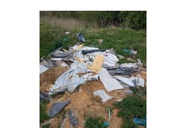 Rubbish dumped in a picturesque meadow near Market Harborough has still not been cleared away – almost a month after the alarm was raised.