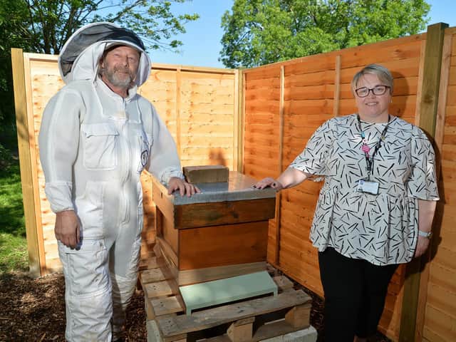 Bee keeper Jak Law and Simone Harrison, deputy head at Farndon Fields Primary School, with their newly installed bee hive.
PICTURE: ANDREW CARPENTER
