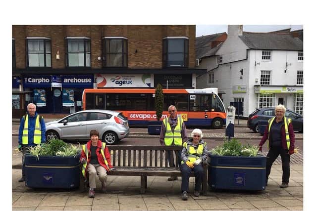 Harborough in Bloom volunteers with the floral displays - before they were stolen.