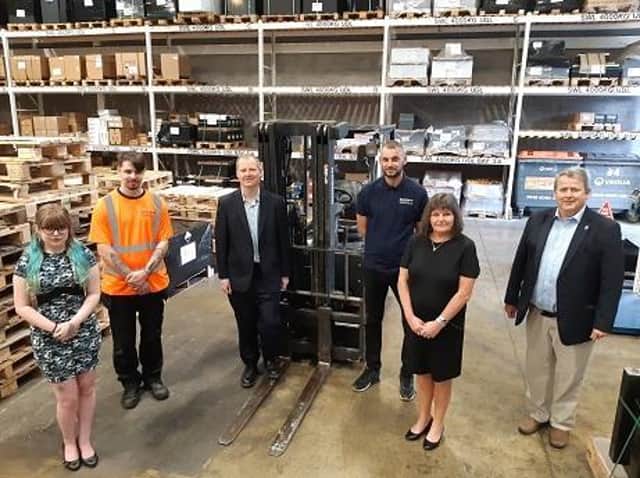 Brooke Smith, Calvin Campbell, Neil O’Brien MP, warehouse manager Matt Coyne, business manager Penny Wallace, and Cllr Phil King at the Battery Service Hub.