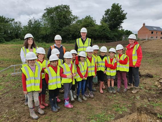 Excited pupils have buried a time capsule – starring a picture of their England football heroes - in Hallaton.