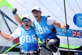 Dylan Fletcher (right) and Stuart Bithell  celebrate winning gold in the Men's Skiff 49er class medal race in Tokyo. Picture by Phil Walter/Getty Images
