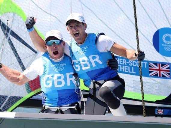 Dylan Fletcher (right) and Stuart Bithell celebrate winning gold in the Men's Skiff 49er class medal race in Tokyo. Picture by Phil WalterGetty Images