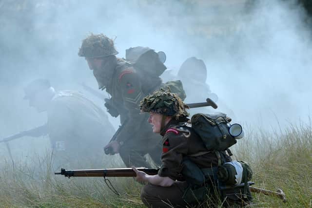 Reenactors depict the soldiers of the Royal Warwickshires conducting what appears to be a section attack. Privates are equipped with the formidable Enfield .303 rife while NCOs wield what appear to be a Sten submachine gun and a Lanchester submachine gun. Lanchesters were an early-war British copy of a German weapon. Photo by Andrew Carpenter.