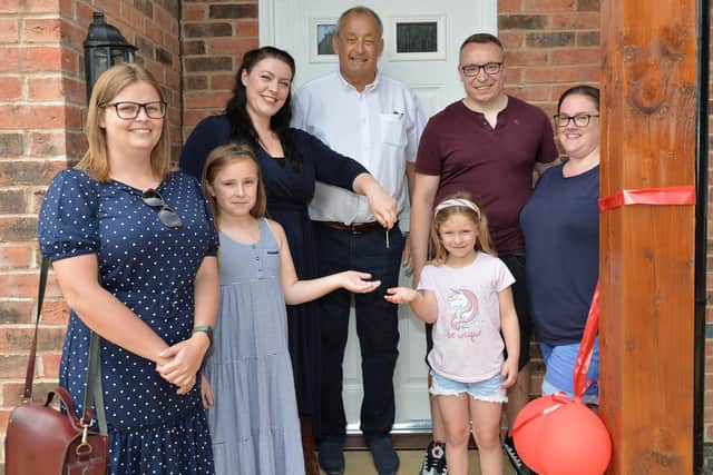 Keys handed over to new residents...from left, Rosie Sweeney of Almshouse Association, Layla Kirby (8), Alicia Kearns MP, Peter Crewe chairman, Bella Kirby (8), Ryan Kirby and Amanda Kirby.
PICTURE: ANDREW CARPENTER