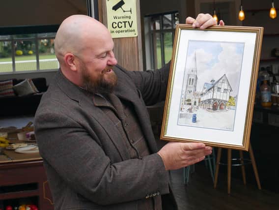 Revd James Pickersgill with a picture of  St Dionysius Church and the Old Grammar School.