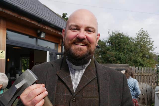 Revd James Pickersgill with an unusual present - and axe for his woodcutting!