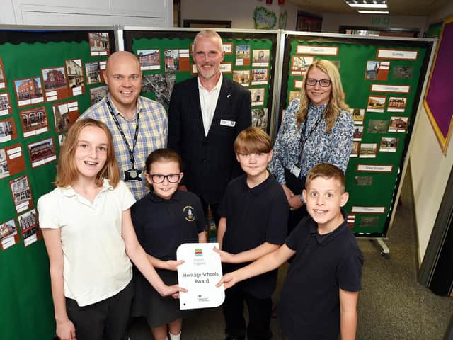 Back row: Teacher Noel Burton, Ismail Dale of Historic England and headteacher Nikki Matthew. Front: Year 6 pupils Chloe, Kitty, Dylan and Adam with the Heritage School's Award.
PICTURE: ANDREW CARPENTER