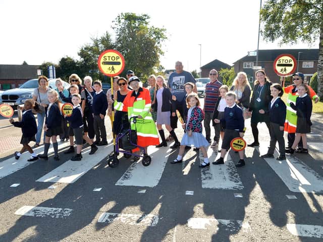 Hilda Swarbrick celebrated her 104th birthday by becoming a lollipop lady once again pictured with past and present students on Orchard Road in Broughton Astley.
PICTURE: ANDREW CARPENTER