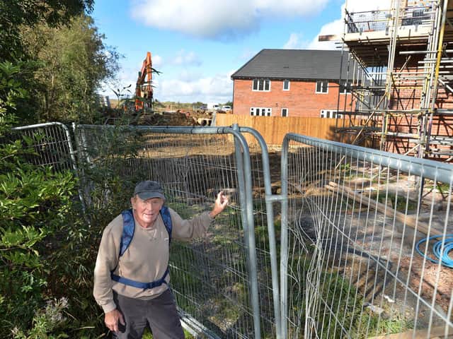 Walker Peter Pollack is prevented from walking any further on the Wellington Place site.
PICTURE: ANDREW CARPENTER