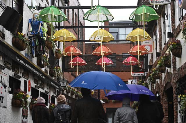 Umbrellas were out in Belfast's Cathedral Quarter as Northern Ireland was battered by heavy rain from Storm Dudley.