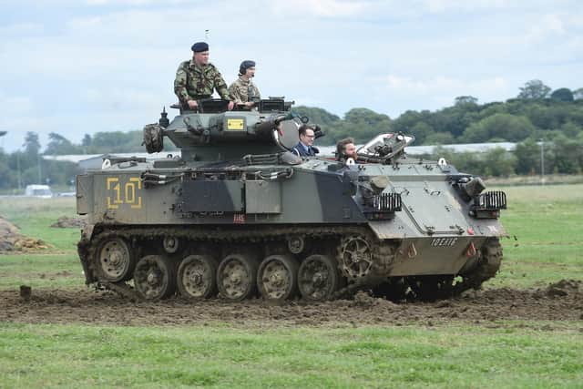 Rides in armoured vehicles.
PICTURE: ANDREW CARPENTER