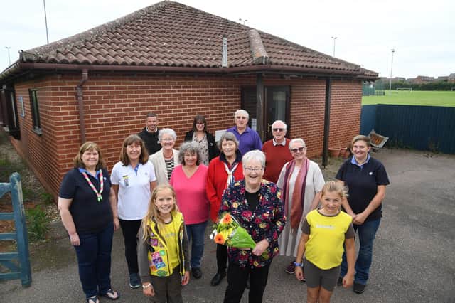 Centre, Eileen Watts retires after 32 years with the girl guides in Market Harborough outside the Hayfields Guide HQ.