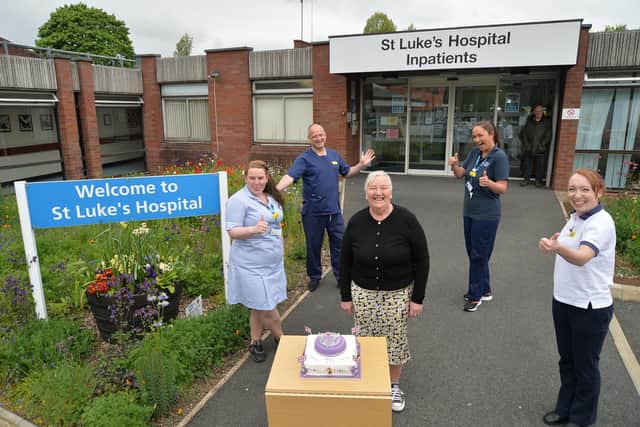Centre, Barbara Johnson presents the Jubilee Celebration cake she won to from left, Abigail Waller, Dan Spence, Sally Swift and Rachael Draper outside St Luke's hospital.PICTURE: ANDREW CARPENTER