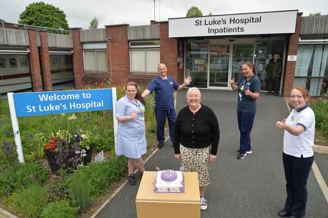 Centre, Barbara Johnson presents the Jubilee Celebration cake she won to from left, Abigail Waller, Dan Spence, Sally Swift and Rachael Draper outside St Luke's hospital.
PICTURE: ANDREW CARPENTER