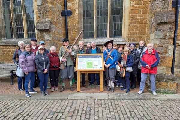 Royalist soldiers and walkers by the restored information boards