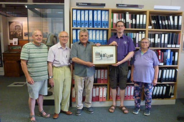 Historical Society committee members present the picture to the museum: from left Michael Hitchcox, David Holmes, Len Holden and museum curator Tim Savage, and Pat Perkins.