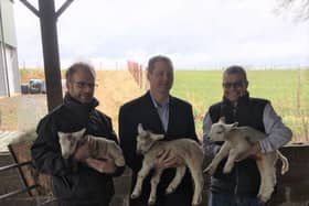 MP Neil O'Brien and local farmers with lambs