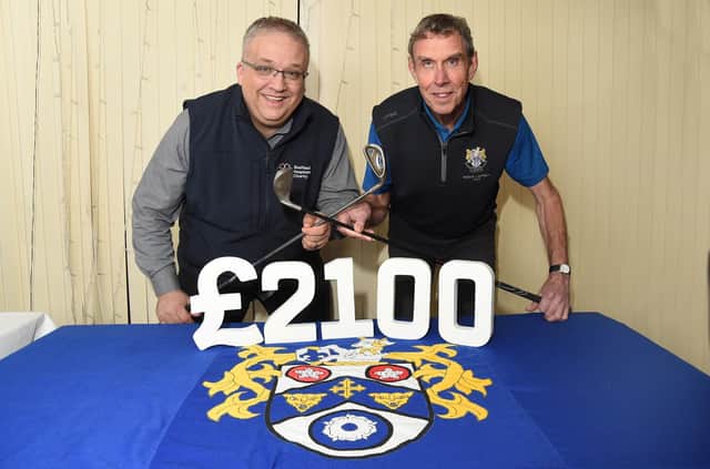 Right - Outgoing Men's Captain at Market Harborough Golf Club Eric Graham during the donation to Gareth Aston, the Chief Executive of the Sheffield Hospitals Charity.