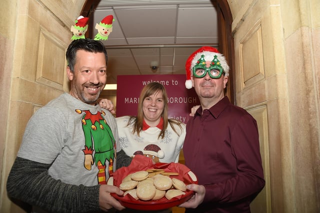 Anthony Honey, Jodie Mallett and Craig Severn of Market Harborough Building Society hand out minced pies and mulled wine.