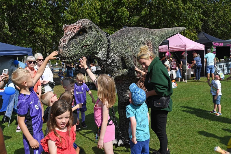A dinosaur meets visitors during the Summer Fayre.