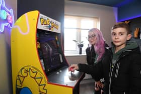 Visitor Josh Lattimore tries out his luck on the Pac-Man machine with mum Lucy Lattimore