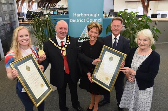 Chairman Stephen Bilbie presents Freedom of the District scrolls to, from left, gold medalist Laura Sugar and Dylan Fletcher-Scott's parents Jane and Graham Fletcher, with Sarah Wright whose husband Chris Wright was Dylan's first coach who inspired him to compete.