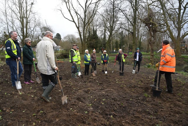 Far right, Richard Moss demonstrates how to plant a tree.