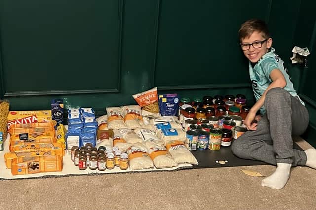 Proud Henry with his 125-strong foodbank haul.