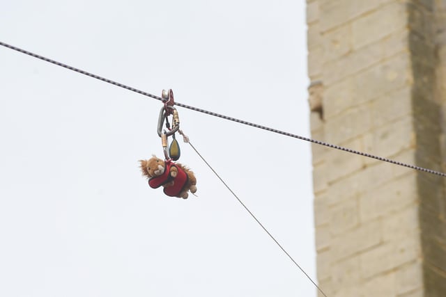 A squirrel teddy gets sent down the zip wire.