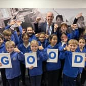 Staff and pupils celebrate the 'good' news.