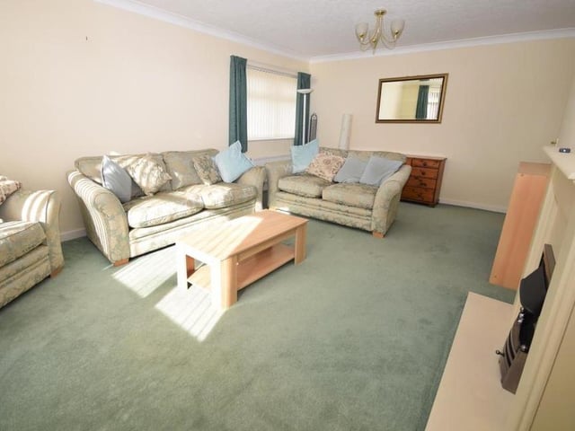 A final check on the lounge. The feature fireplace, with electric fire, adds to the warm and cosy atmosphere in the room, as do a couple of radiators.