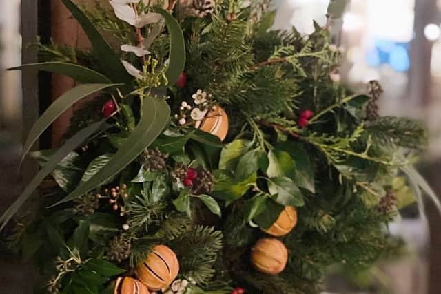 Create a festive wreath out of only natural materials and add blows and ribbons