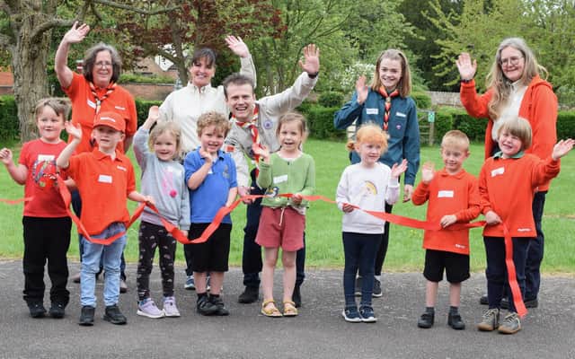 Children as young as four are now being welcomed with open arms by a thriving Scout group in a Harborough district village.
The red ribbon was cut by Jacker Barber, Leicestershire Scouts Youth Commissioner.