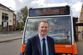 MP Neil O'Brien next to the number 33 bus
