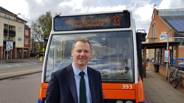 MP Neil O'Brien next to the number 33 bus