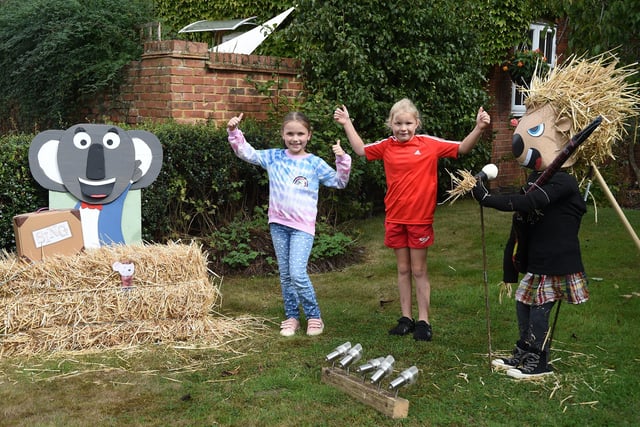 Sing...Ida Freer aged eight and Alicia Woolley aged nine enjoy the scarecrow festival in Lubenham.